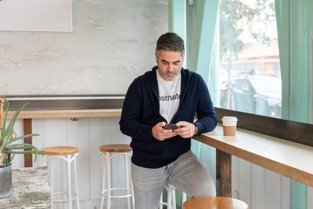 Man sitting at a counter, looking at his phone